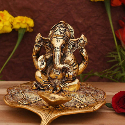CraftVatika Gold Toned Aluminium Ganesh with Diya Idol
