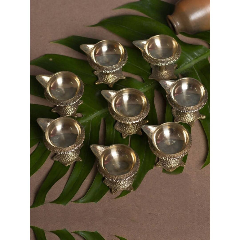 Tied Ribbons Gold Toned 8 Pieces Decorative Brass Diyas With Tortoise Base